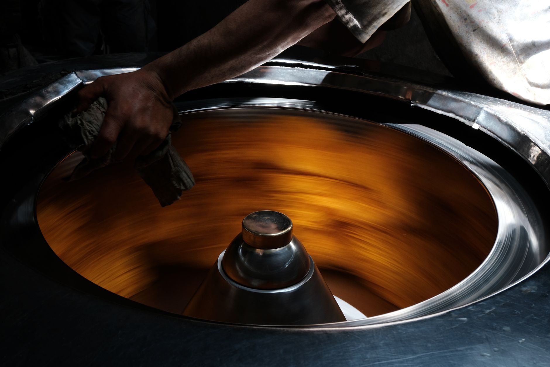 cabbing machine with diamond wheels shaping a polished cabochon