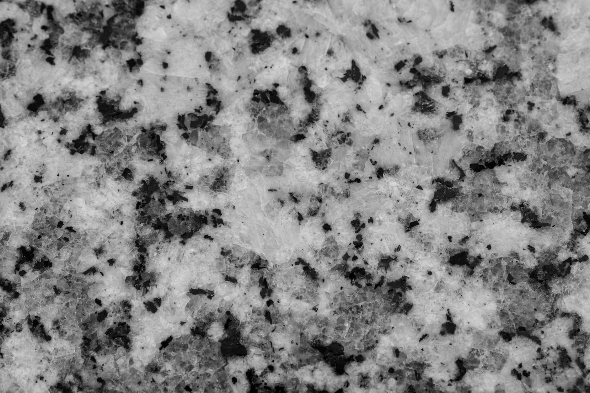 Estwing rock hammer with pointed tip lying on a granite boulder