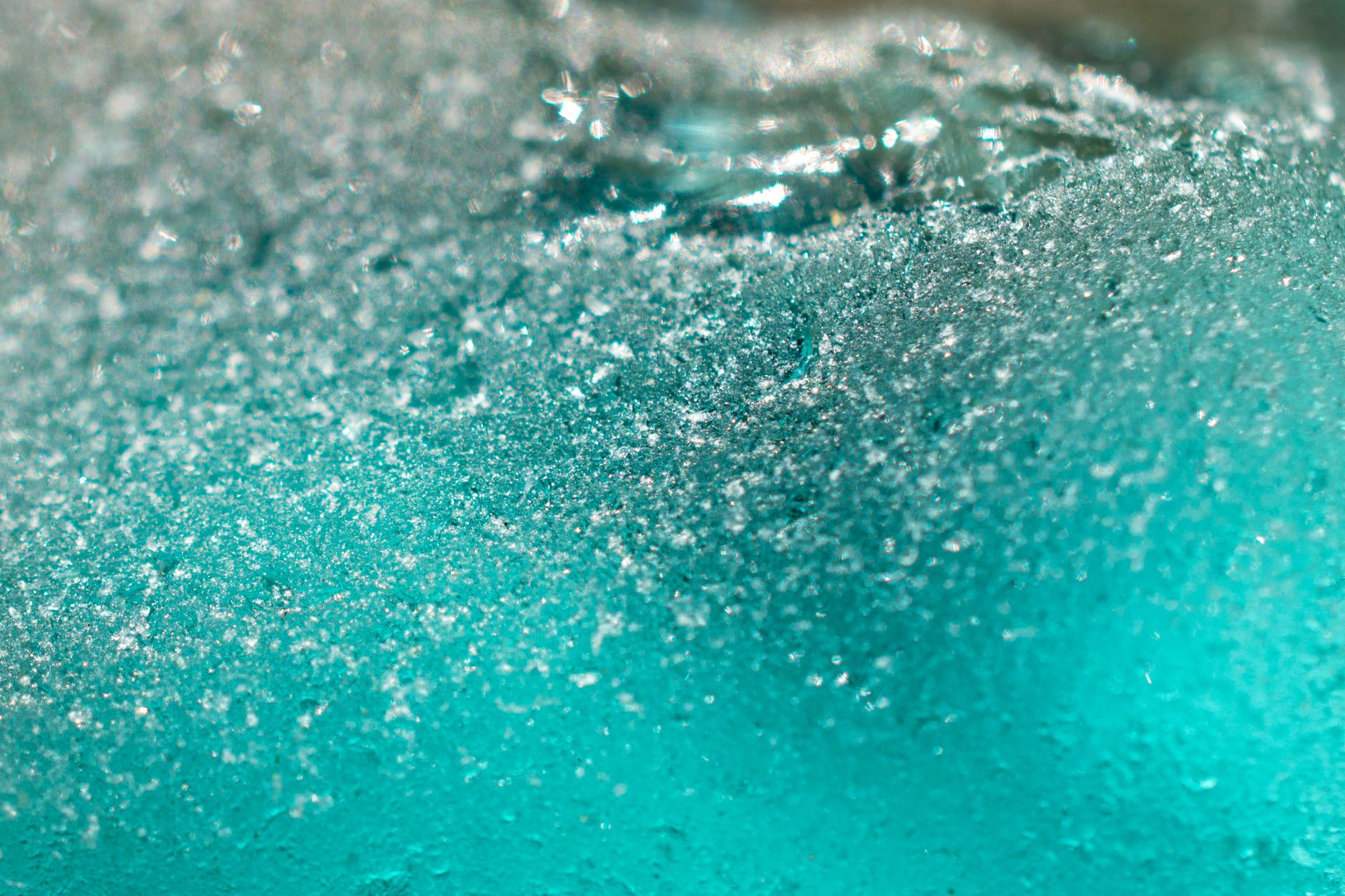 frosted recycled glass pieces inside a small rotary rock tumbler barrel