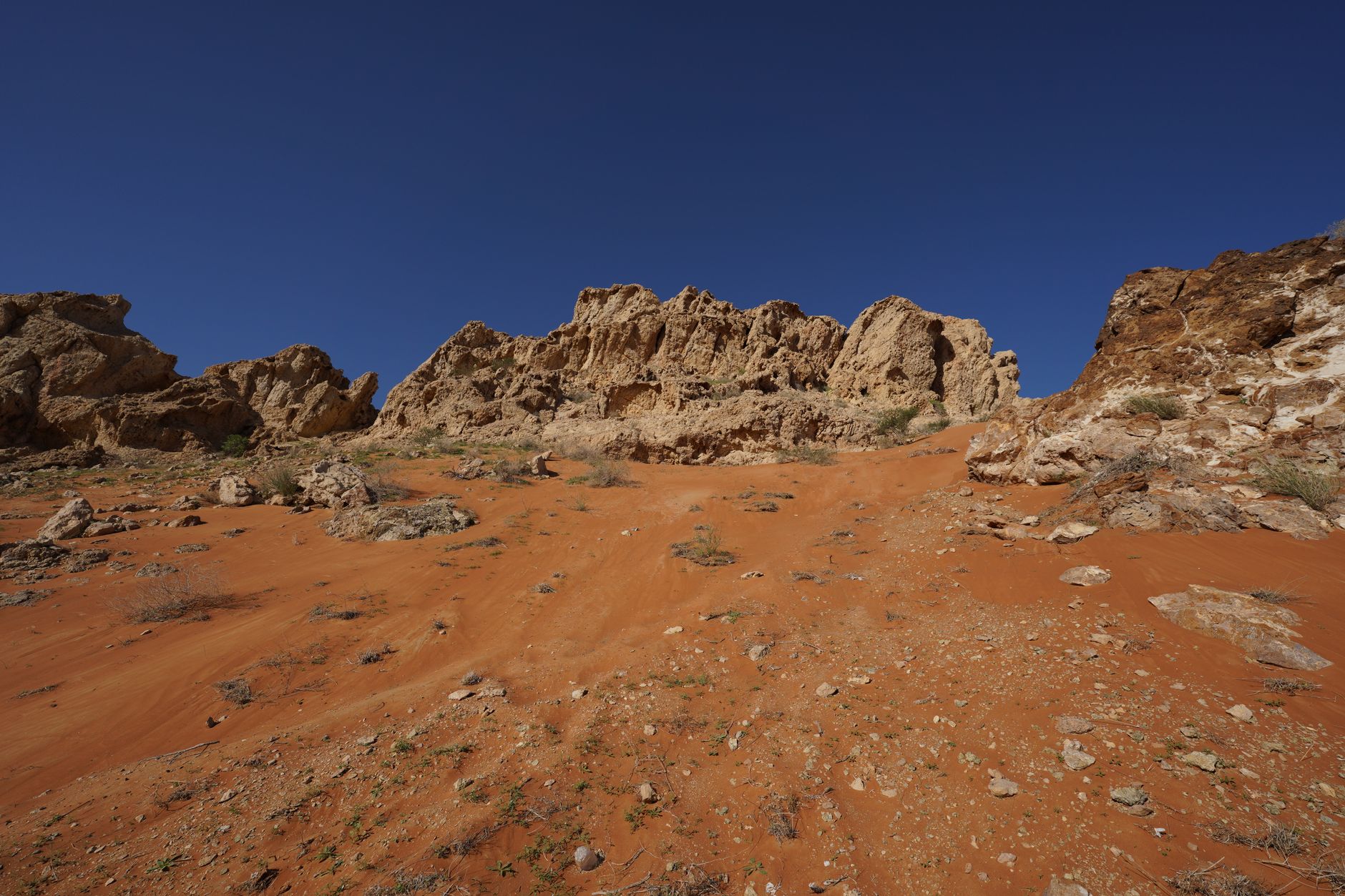 a remote desert public land landscape with a low rocky outcrop suitable for rockhounding