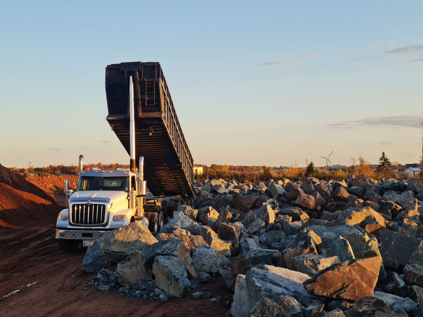 rock hammer and classifier screens laid out on a truck tailgate