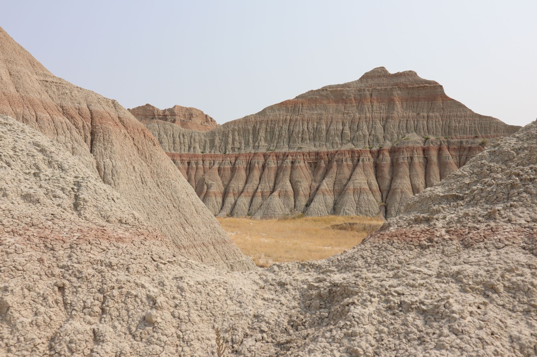 A rocky Wyoming badlands landscape with scattered collectible stones on the ground